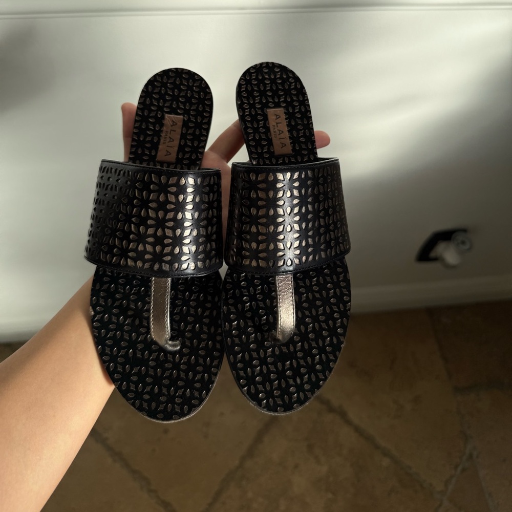 Alaia laser cut flat sandal